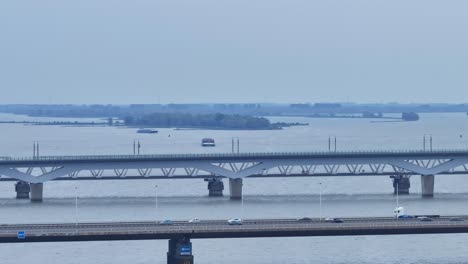 Drone-aerial-shot-panning-across-with-bridges-in-view-and-busy-cars-passing-by