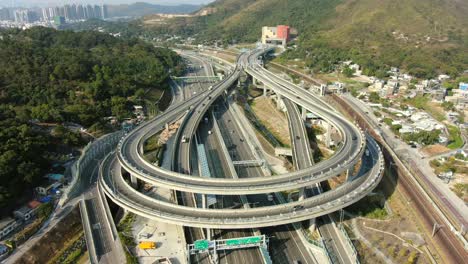 traffic on a massive highway interchange with multiple levels and loop shaped road in hong kong, aerial time lapse