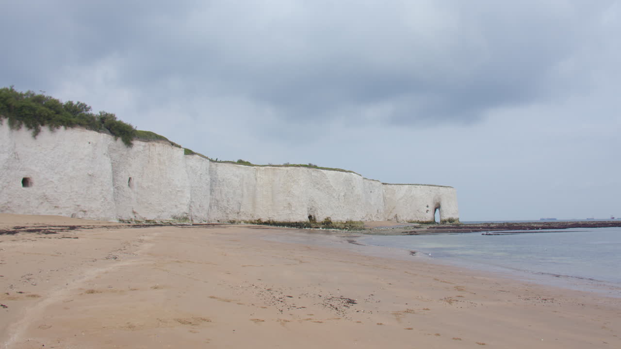 Extra wide shot of kingsgate beach with white cliffs and the King's gate arch in background
