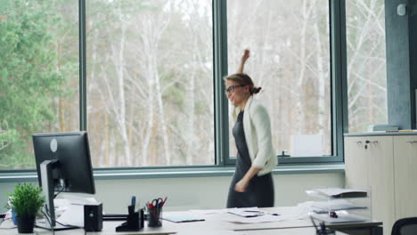 happy businesswoman celebrating in office
