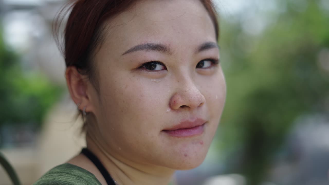 Woman with tears in her eyes, looks sad and tired.