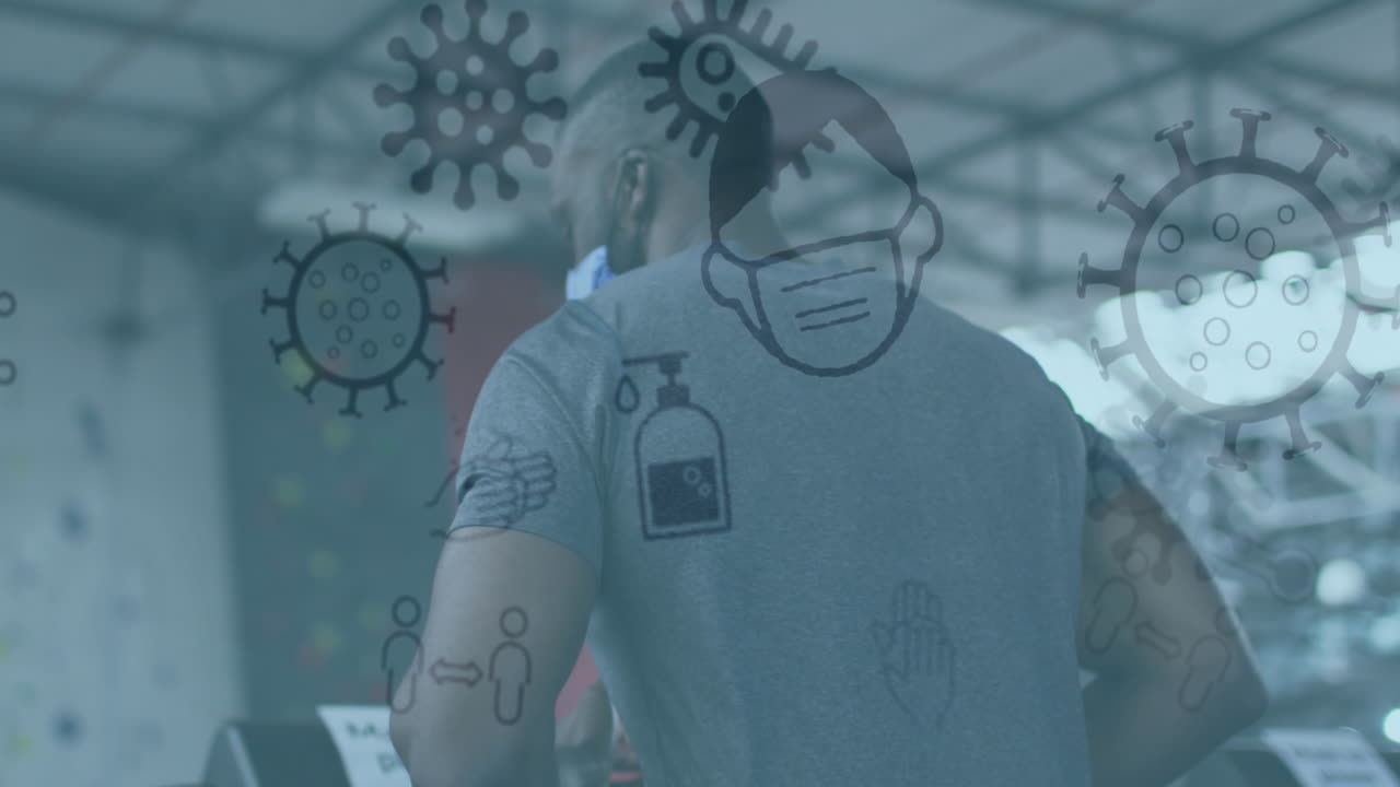 animación de iconos de covid-19 flotando sobre un hombre afroamericano con máscara facial entrenando