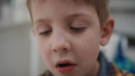 portrait-funny-little-boy-eating-cookie-looking-shy-kid-with-childhood-curiosity-at-home-4k