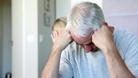 stressed couple sitting on bed