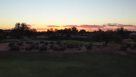 silhouette parallax view of a sunset at a luxury golf course