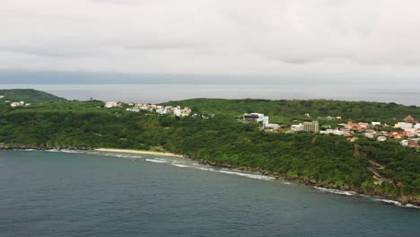 Spectacular-view-aerial-pan-shot-reveals-the-shape-of-the-islet-along-with-beautiful-diffused-horizon-on-an-overcast-day,-Xiaoliuqiu-Lambai-Island,-Pingtung-county,-Taiwan