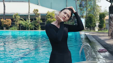 Young-Woman-Swimmer-Doing-Neck-Strecthing-And-Warming-Up-At-Pool