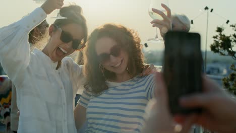 caucasian woman make a photo to best friends at the party.