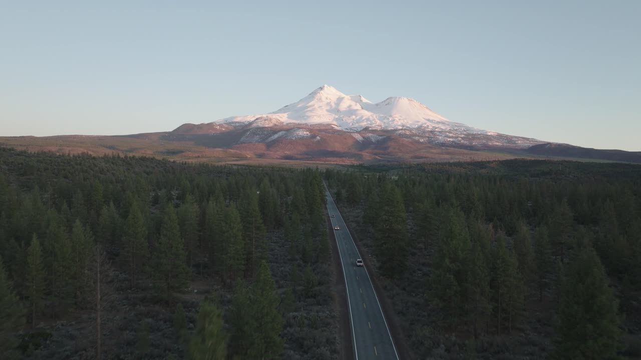 Mount Shasta Trinity Northern California National Forest Aerial Footage of a Mountain Road Through Forest with Snowy Peak in Spring