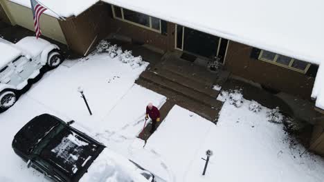 Light-storm-resulting-in-snowfall-being-shoveled-by-a-man