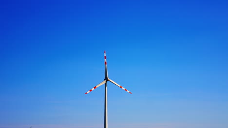turbine towers in blue sky. a modern wind turbine is prominently displayed under a bright blue sky, illustrating renewable energy in action