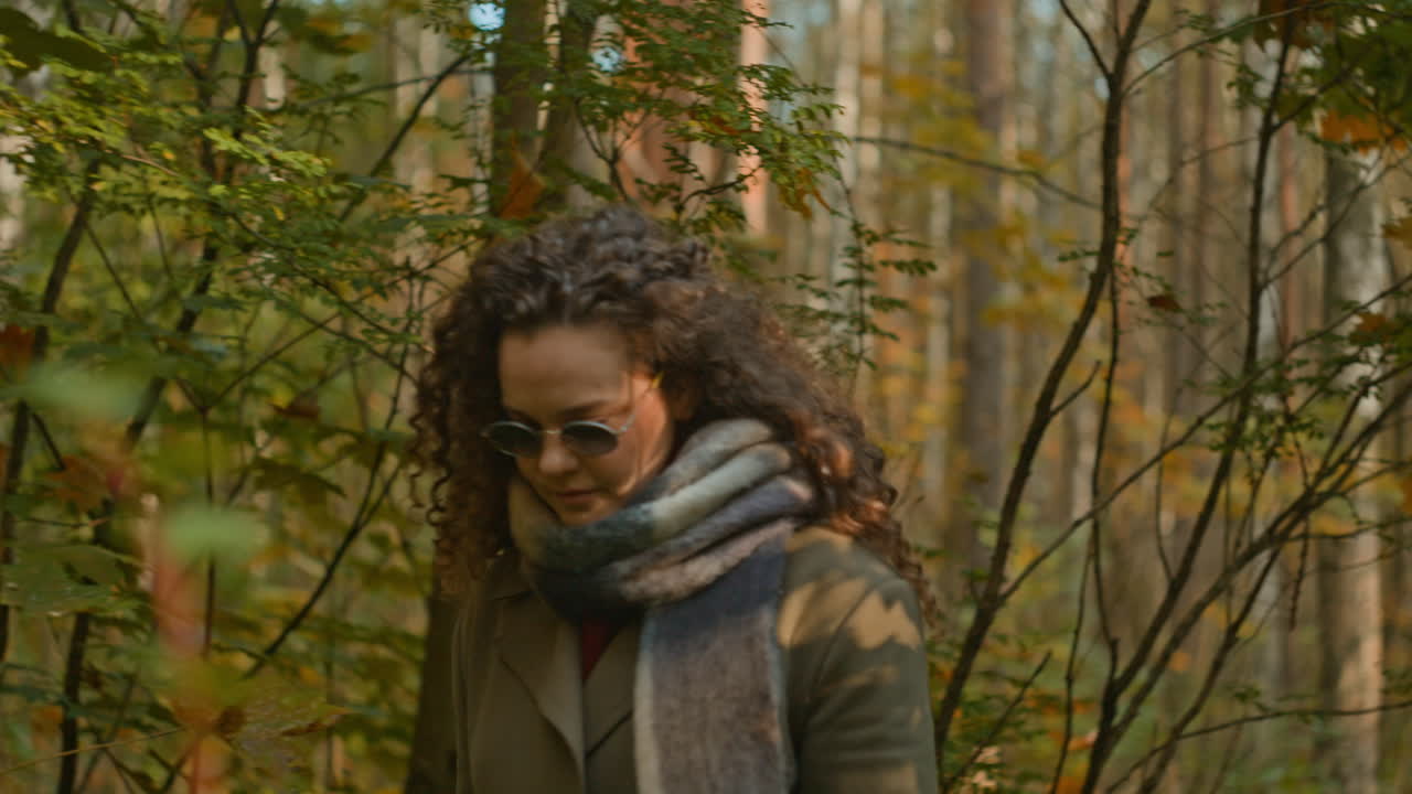 Woman with Curly Hair in Autumn Forest
