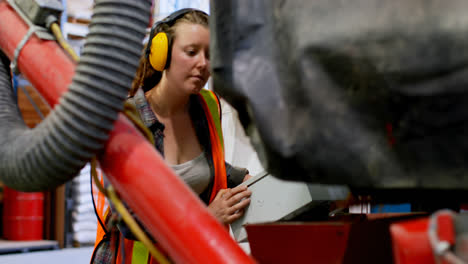 Side-view-of-young-caucasian-female-worker-working-in-factory-4k