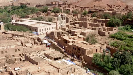 Overview-of-tourists-walking-around-in-Tuyoq-city,-valley-in-Xinjiang,-Tuyuk-aerial-of-oasis-village-in-the-Taklamakan-desert,-Flaming-Mountains,-Xinjiang-Uighur,-Region-of-China