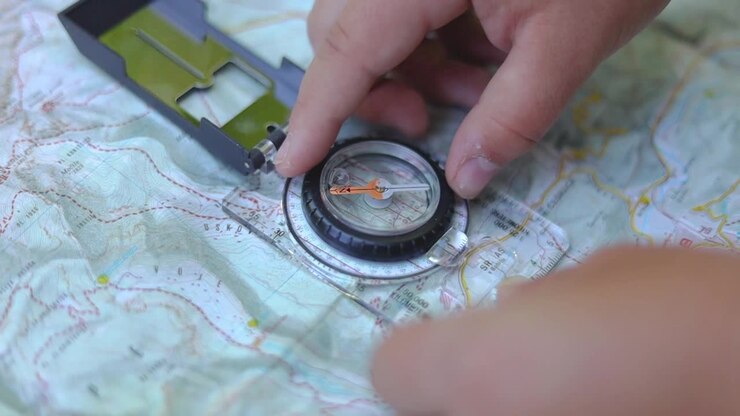 Close up of a compass on top of the hiking map