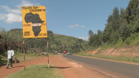 A sign marks the equator line in Kenya Africa