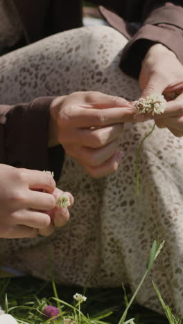 hands weaving small flowers