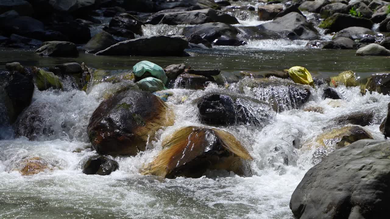 Water is flowing through a mountain torrential river.
