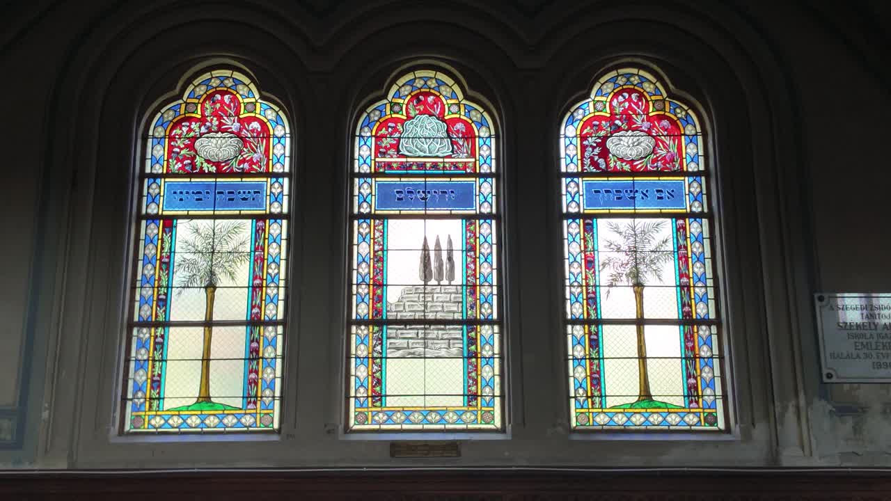 Detailed view of stained glass inside Szeged Synagogue, highlighting ornate patterns and architectural beauty
