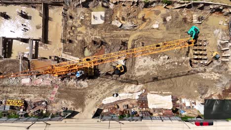 aerial drone footage of a large construction site with heavy machinery and workers