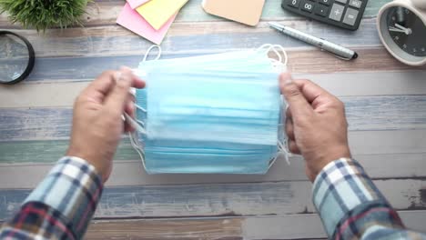 person holding a stack of face masks