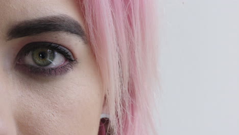 close-up-woman-eye-open-looking-at-camera-punk-female-pink-hair-on-white-background