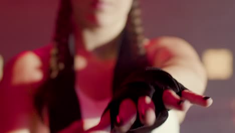 close up of an unrecognizable caucasian sportswoman  wrapping hands with boxing bandages at gym