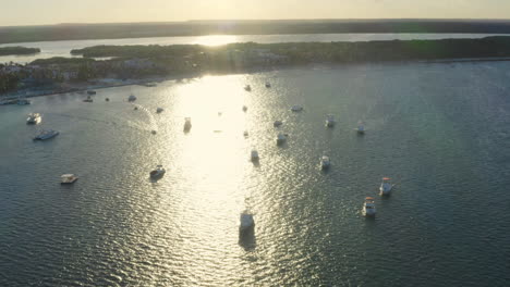 Boats-and-yachts-on-coast-of-Punta-Cana,-Dominican-republic,-at-sunset