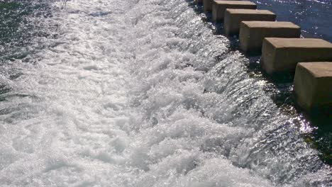 Agua-En-Movimiento-Rápido-Sobre-Un-Vertedero-Creando-Agua-Blanca-Corriendo-Corriente-Abajo