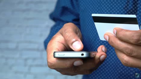 man making a mobile payment with credit card