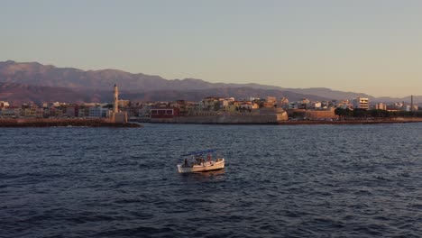 aerial - small fishing boat floating in chania greece