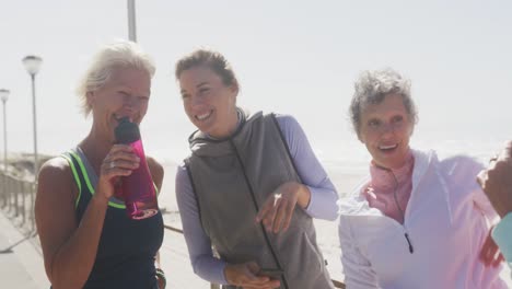 athletic women taking picture on the beach
