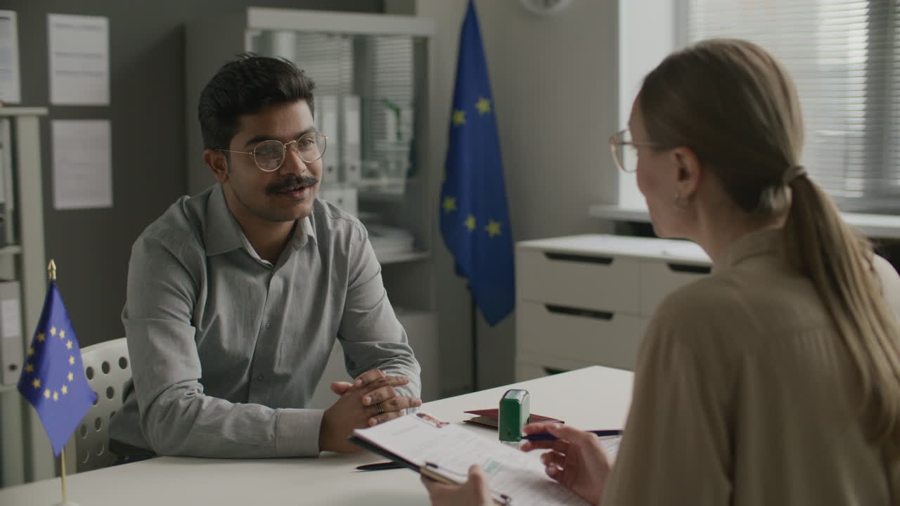 Indian Man Talking to Female Visa Officer during Meeting at EU Embassy