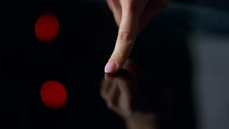 close up of beautiful manicured female finger on black background. macro finger.