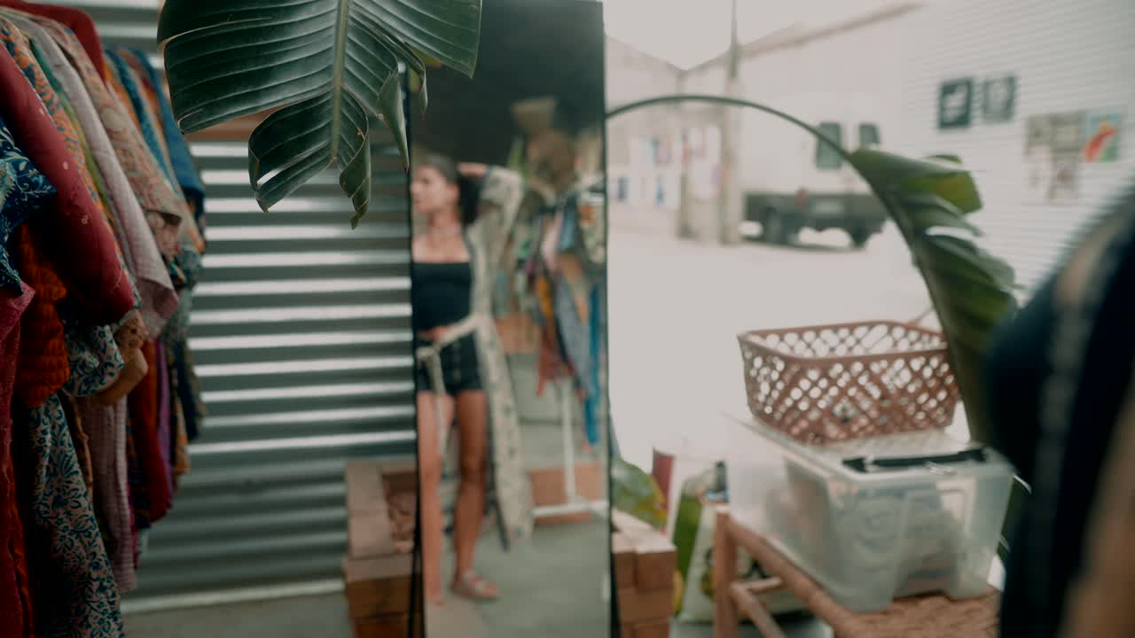 Woman in a mirror reflecting a shop