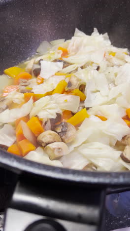 closeup of hot steamy vegetables cooking at kitchen