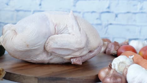 raw whole chicken and ingredients for cooking