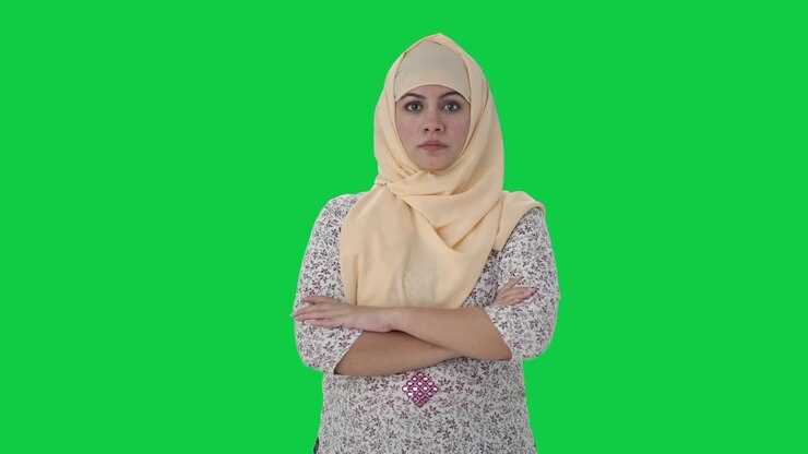 Confident Muslim teacher standing crossed hands Green screen