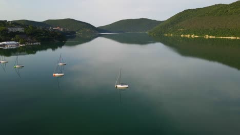 mountain lake with turquoise water and yachts. abrau lake in abrau-durso, russia.