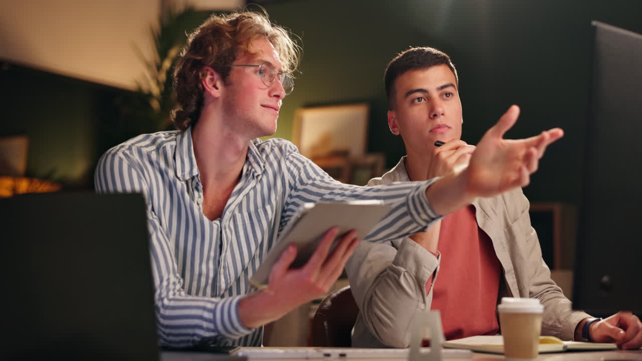Two colleagues working late at the office