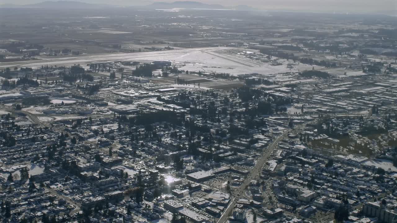 A Snowy View of Abbotsford Airport and Surrounding Neighborhoods in Abbotsford, British Columbia, Canada - Aerial Drone Shot