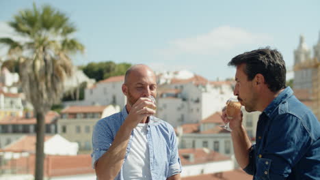 homosexual man drinking champagne on background of cityscape