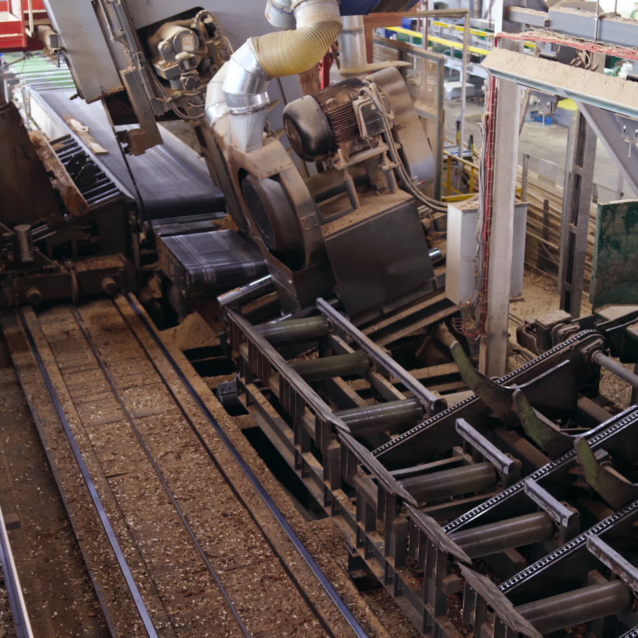 Forest product industries. Sawmill. Process of machining logs in a machine, Heavy industry equipment. Closeup. view from the top. Wood industry facilities.