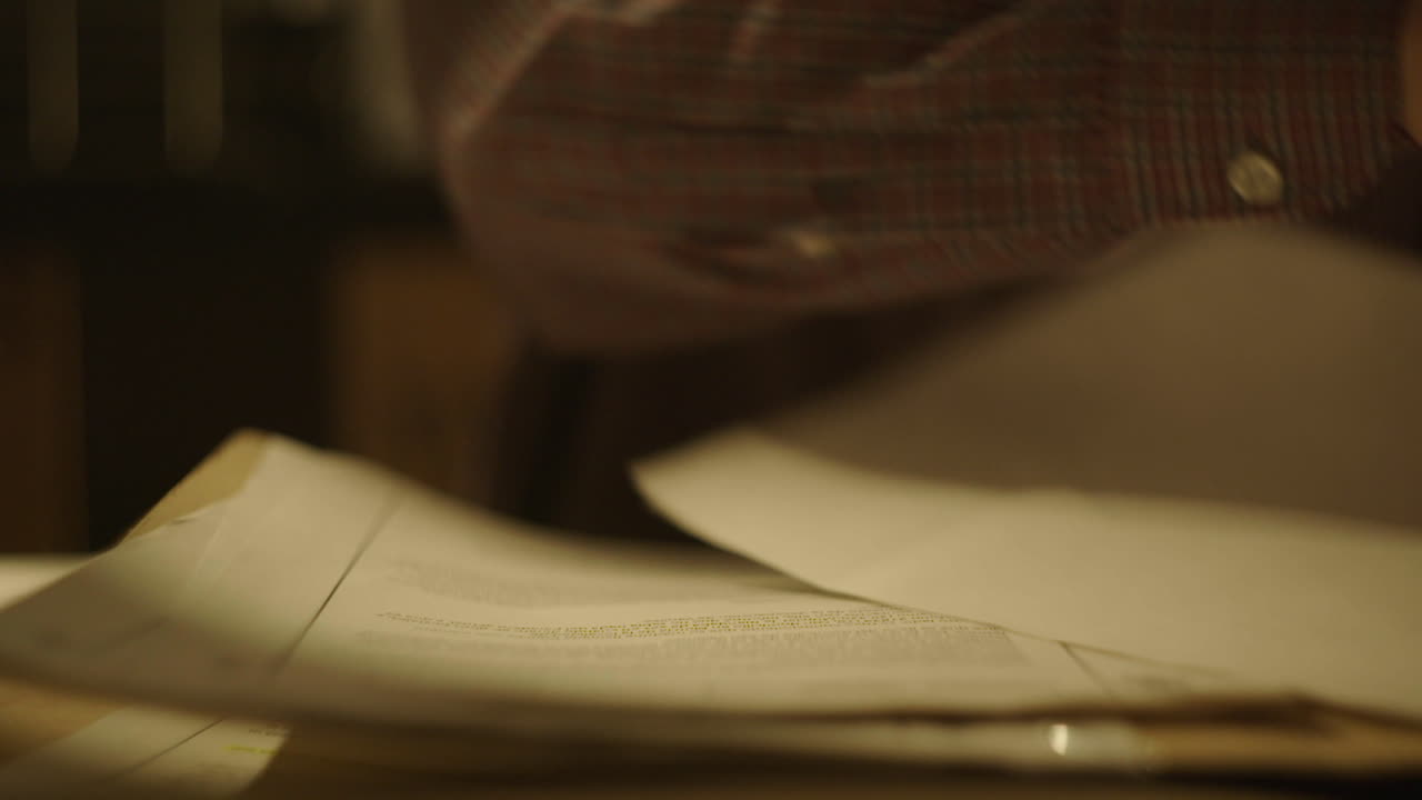 Person Reading Documents at Night