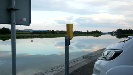 Camper-parking-beside-peaceful-river-during-holidays-in-Europe-in-summer