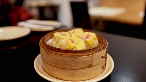 dumplings served in a bamboo steamer basket