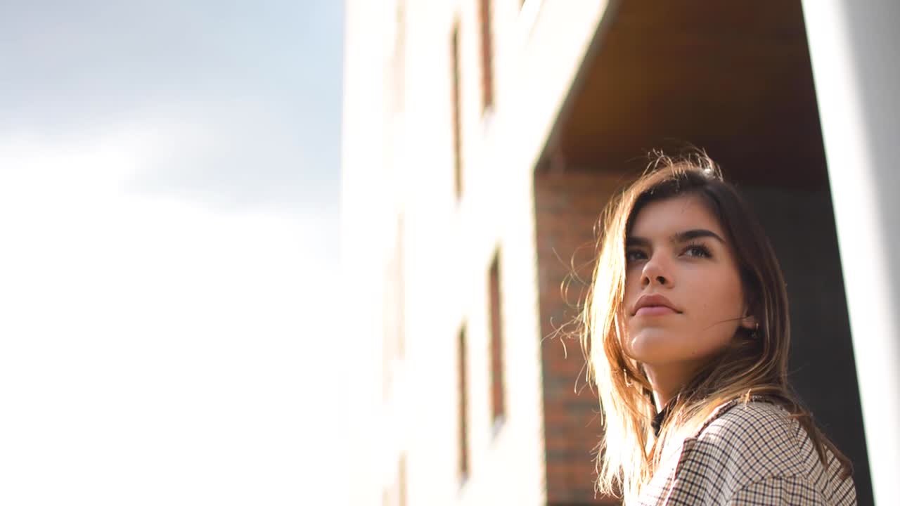 Beautiful shot of a girl staring into the horizon and looking back to what is behind her.