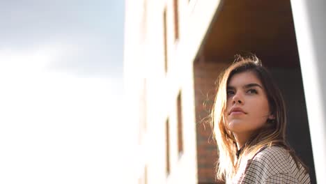 beautiful shot of a girl staring into the horizon and looking back to what is behind her.