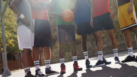 Basketball-players-standing-together-in-basketball-court-outdoors