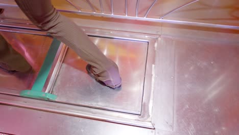 person walking through metal platform